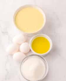 Ingredients for lemon meringue pie dip including eggs, sugar, and lemon mixture.