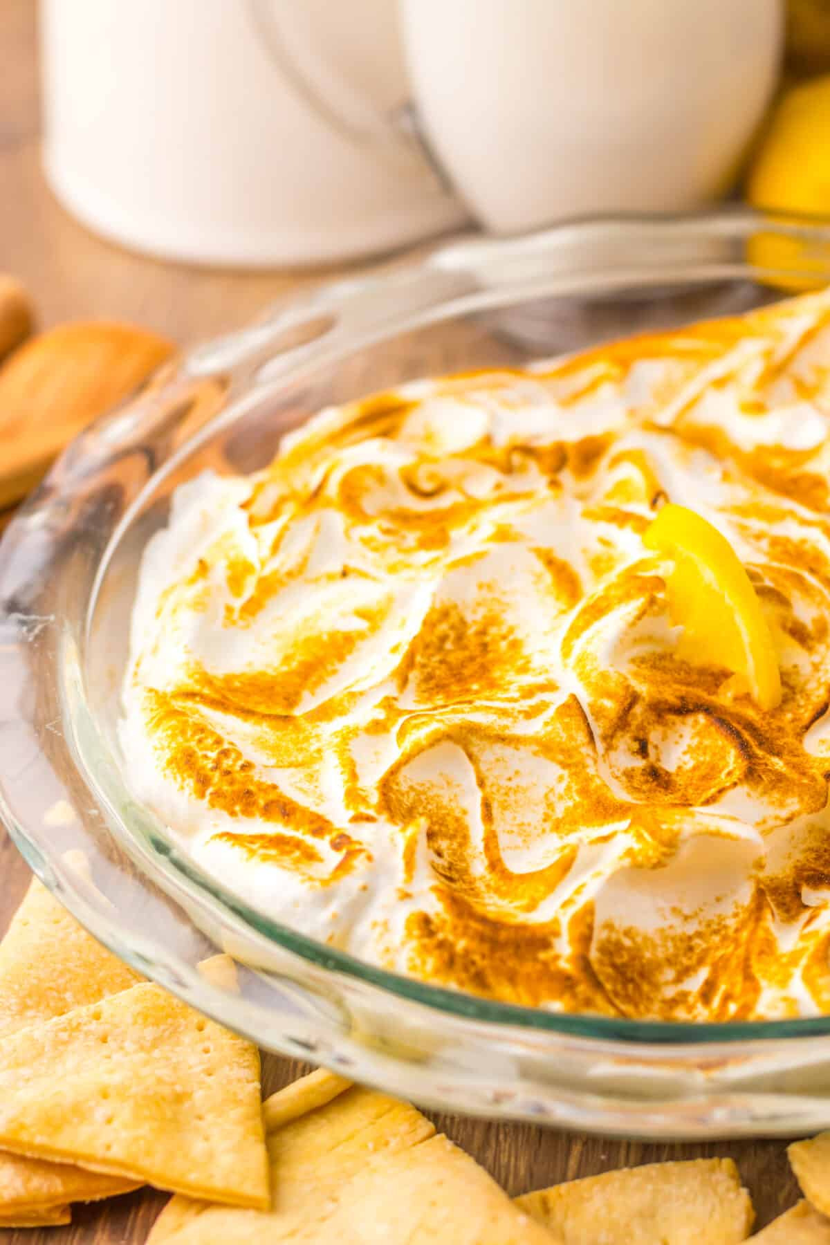 Close-up of creamy lemon dip with fluffy toasted meringue.