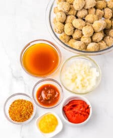 Ingredients for birria meatballs including frozen meatballs, spices, and sauces.