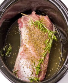 Pork carnitas ingredients including citrus juice and spices for slow cooker recipe.