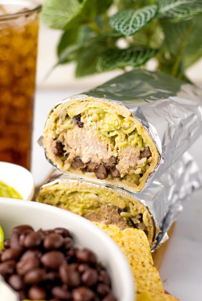 Copycat Chipotle carnitas burrito wrap cut in half.