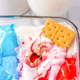 Close-up of baked patriotic s'mores dip with gooey marshmallows and melted chocolate.