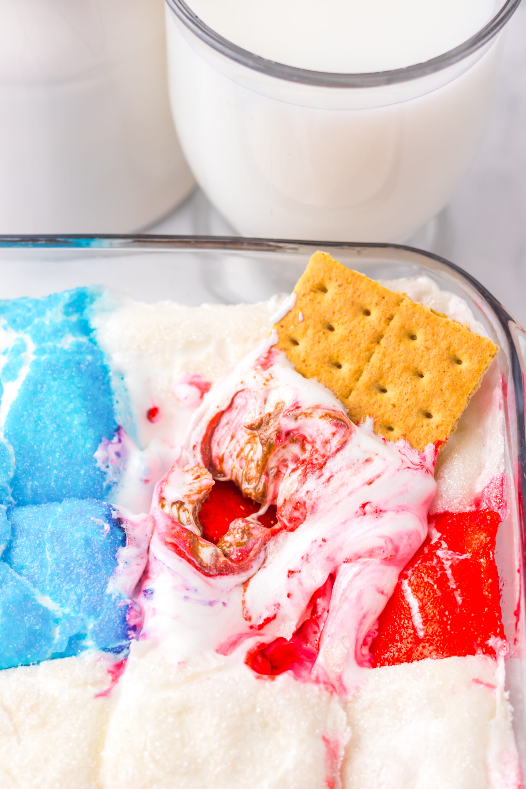 Close-up of baked patriotic s'mores dip with gooey marshmallows and melted chocolate.