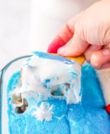 Close-up of baked patriotic s'mores dip with gooey marshmallows and melted chocolate.