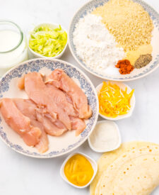 Ingredients for Copycat McDonald's Snack Wraps including chicken, cheese, lettuce, and tortillas.