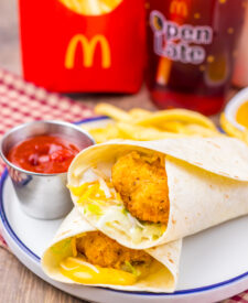 Homemade crispy chicken snack wrap meal with fries and ketchup.