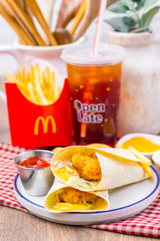 Homemade crispy chicken snack wrap meal with fries and ketchup.