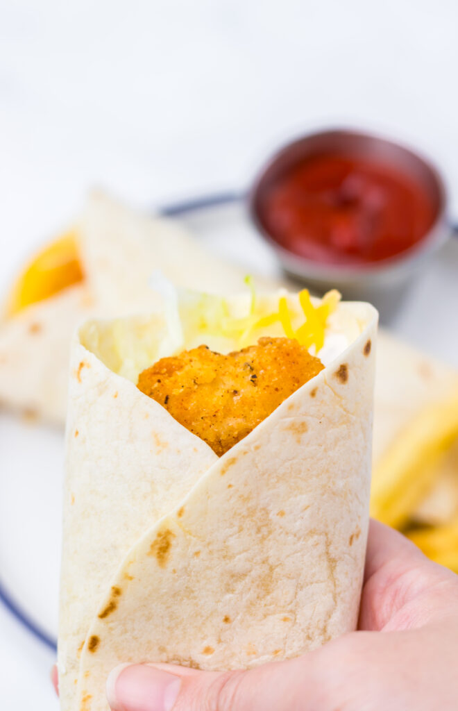 Crispy chicken strip wrapped in a flour tortilla with cheese.