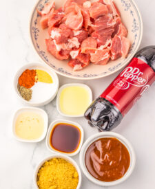 Ingredients for Slow Cooker Dr Pepper BBQ Rib Bites including boneless pork ribs, Dr Pepper, barbecue sauce, brown sugar, and seasonings.