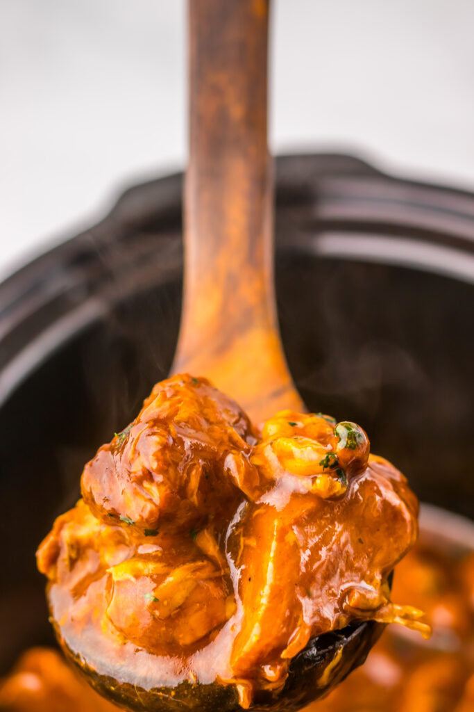 Close-up of tender Slow Cooker Dr Pepper BBQ Rib Bites coated in glossy barbecue sauce.