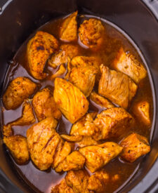 Dr Pepper and barbecue sauce poured over seasoned pork rib bites in the slow cooker.
