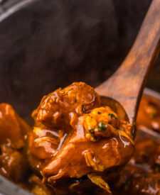 Seasoned pork rib bites cooking in a rich Dr Pepper barbecue sauce.