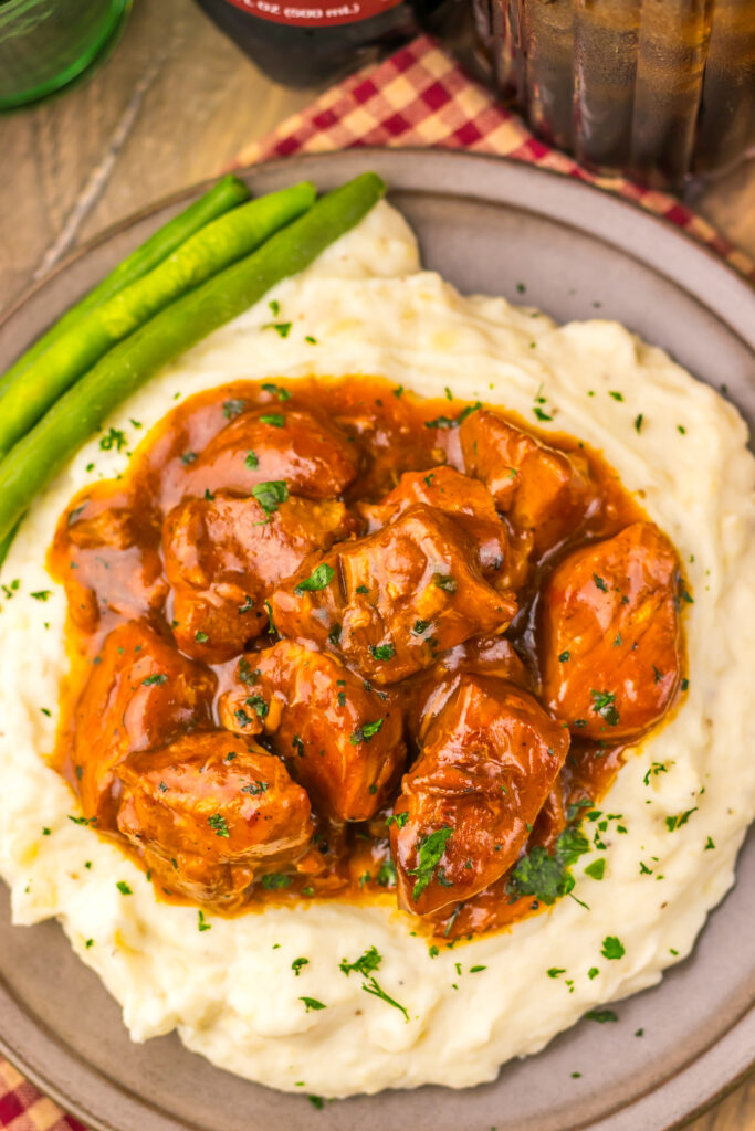 Tender Dr Pepper BBQ rib bites served over mashed potatoes.