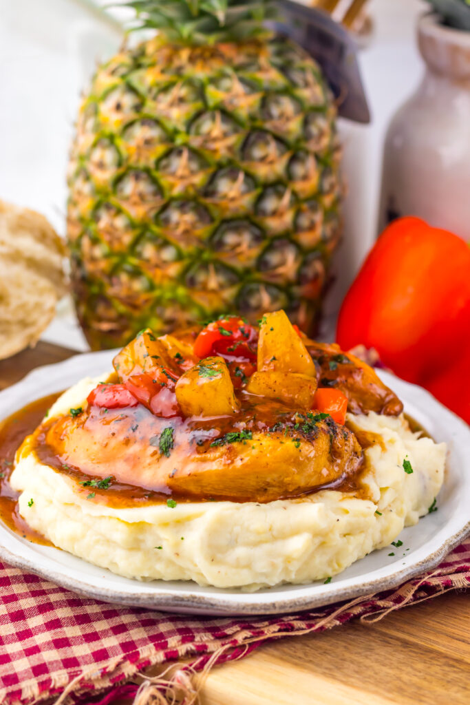 Close-up of Slow Cooker Sweet Chili Pineapple Chicken with pineapple and peppers.