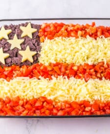 Festive Flag Taco Dip in a 9x13 dish for summer parties.