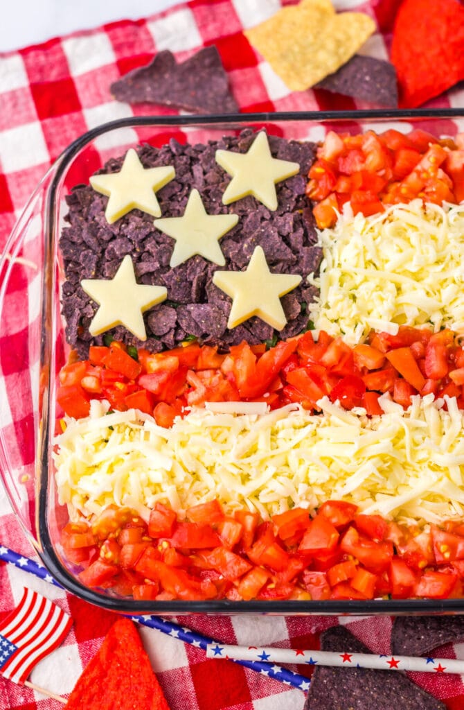 American flag taco dip decorated for Fourth of July celebrations.