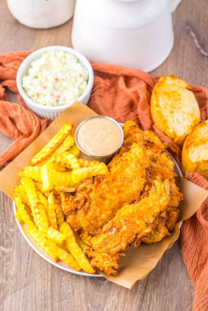 Copycat Raising Cane's chicken tenders served with Texas toast and creamy Cane's sauce.