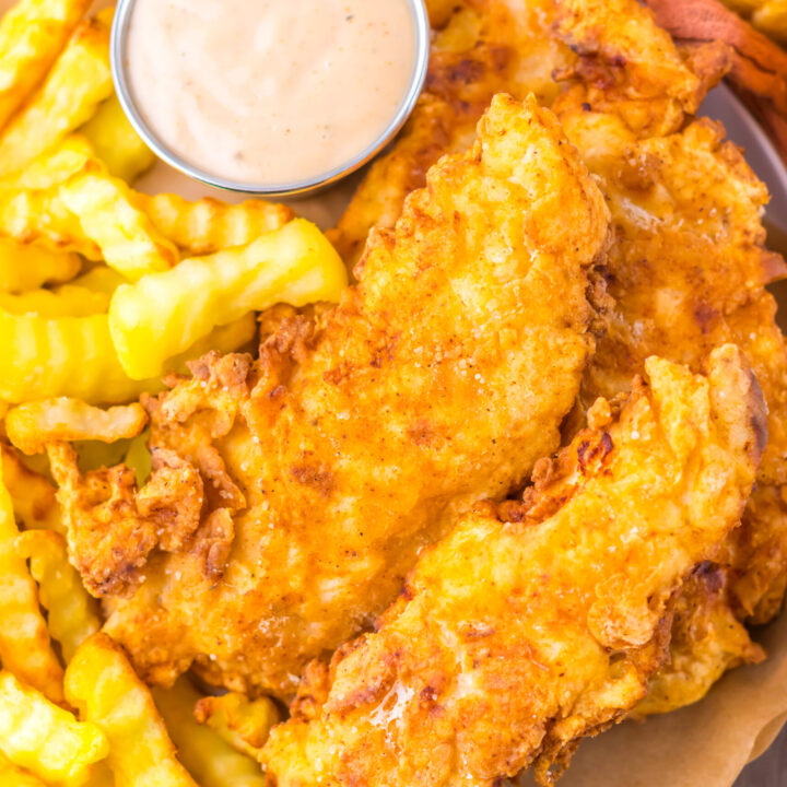 Copycat Raising Cane's chicken tenders served with fries, Texas toast, and Cane's sauce.