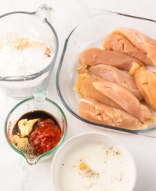 Ingredients for Copycat Raising Cane's Chicken Tenders including chicken tenders, buttermilk, flour, and seasonings.
