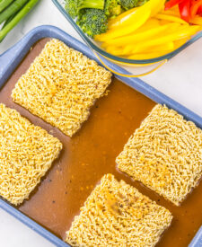 Dry ramen noodles arranged on a sheet pan before baking.