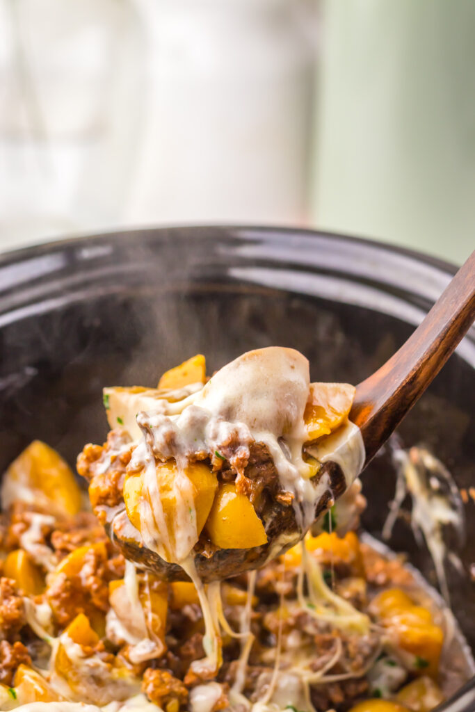 Creamy French onion beef and potatoes spooned from the slow cooker.