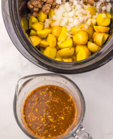 Baby potatoes added to seasoned ground beef in the slow cooker.