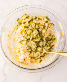 Creamy pickle dip mixed with cheddar cheese and chopped dill pickles.