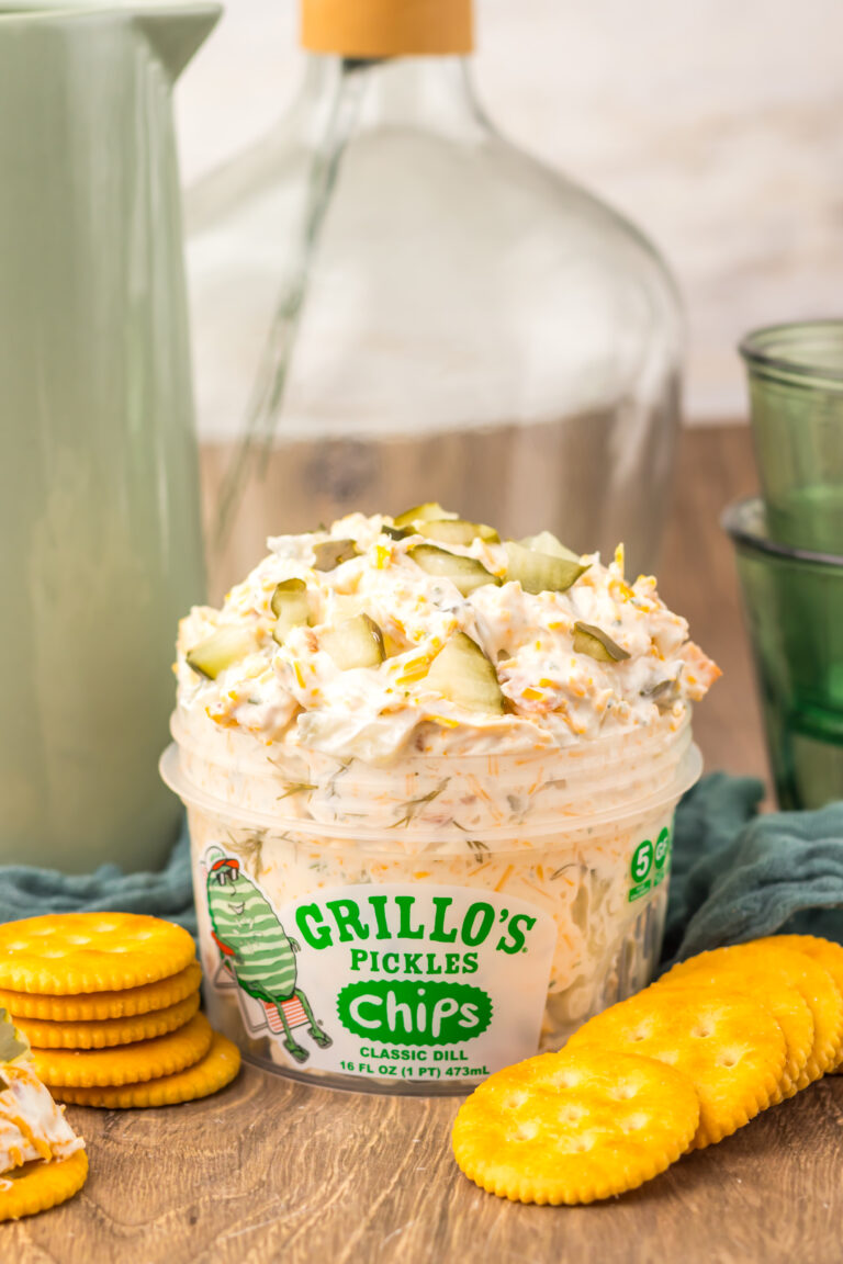Viral Pickle Dip topped with shredded cheddar cheese and chopped pickles.