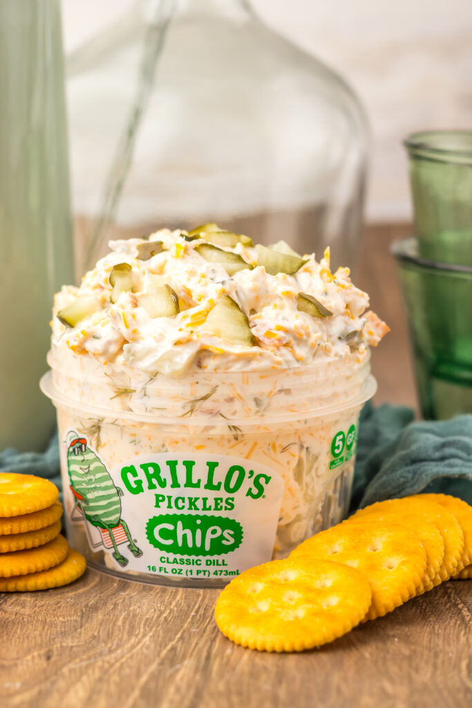 Close-up of creamy Viral Pickle Dip garnished with pickles and cheddar cheese.
