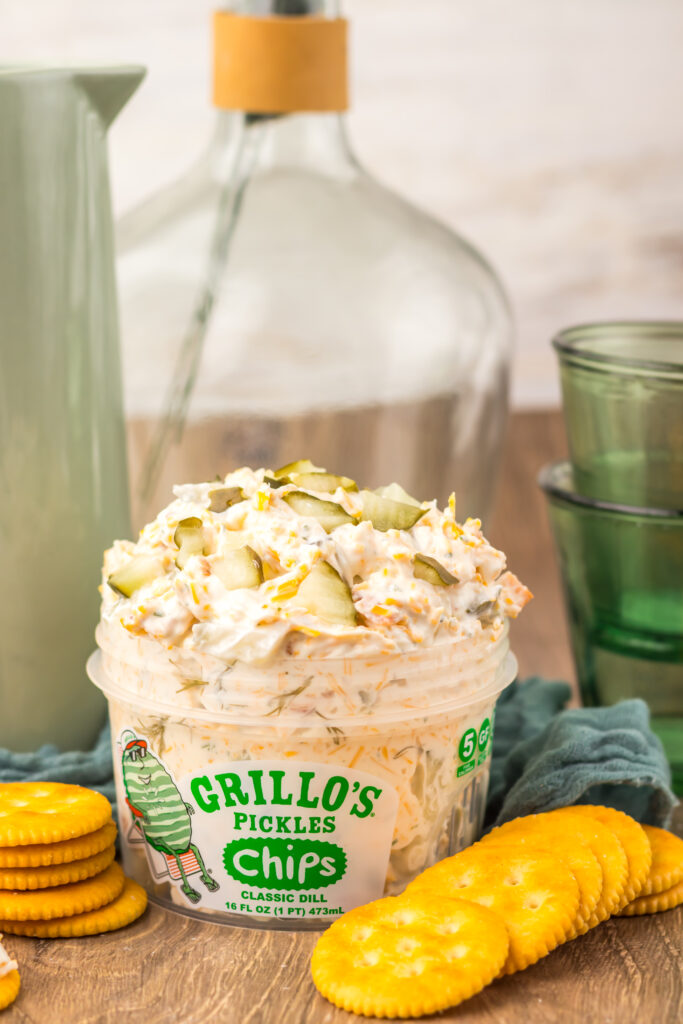 Bowl of Viral Pickle Dip ready to serve with crackers and vegetables.