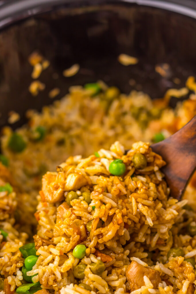 Slow Cooker Chicken Fried Rice finished with peas, carrots, and green onions.