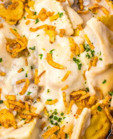 Close-up of Slow Cooker French Onion Ravioli with crispy onions and melted cheese.