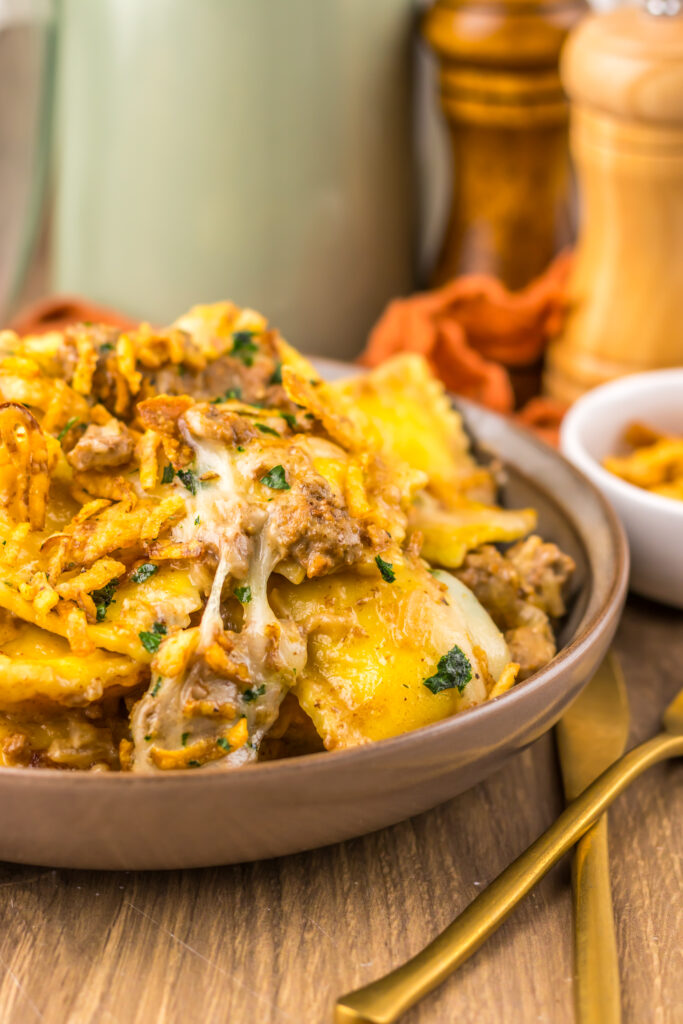 Creamy French Onion Ravioli on a plate with melted cheese.