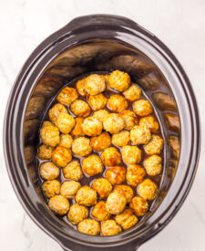 Root Beer Meatballs cooking in the slow cooker with sweet barbecue sauce.