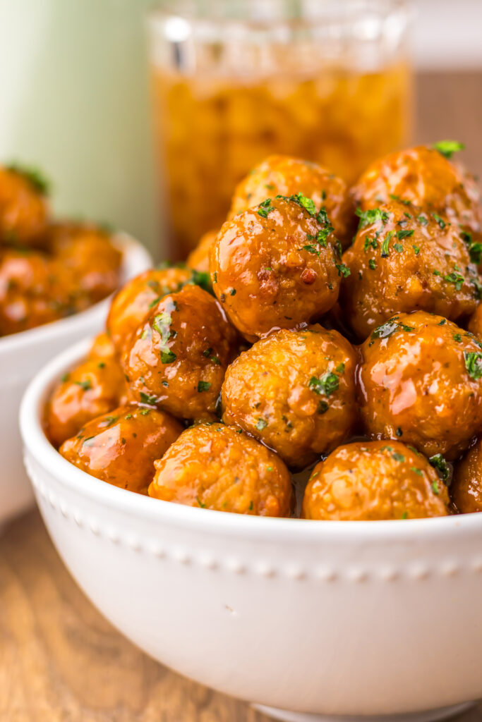 Slow Cooker Root Beer Meatballs garnished with parsley and ready to serve.