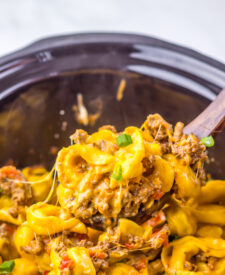 Finished Slow Cooker Taco Tortellini with cheesy pasta, seasoned beef, and green onions.