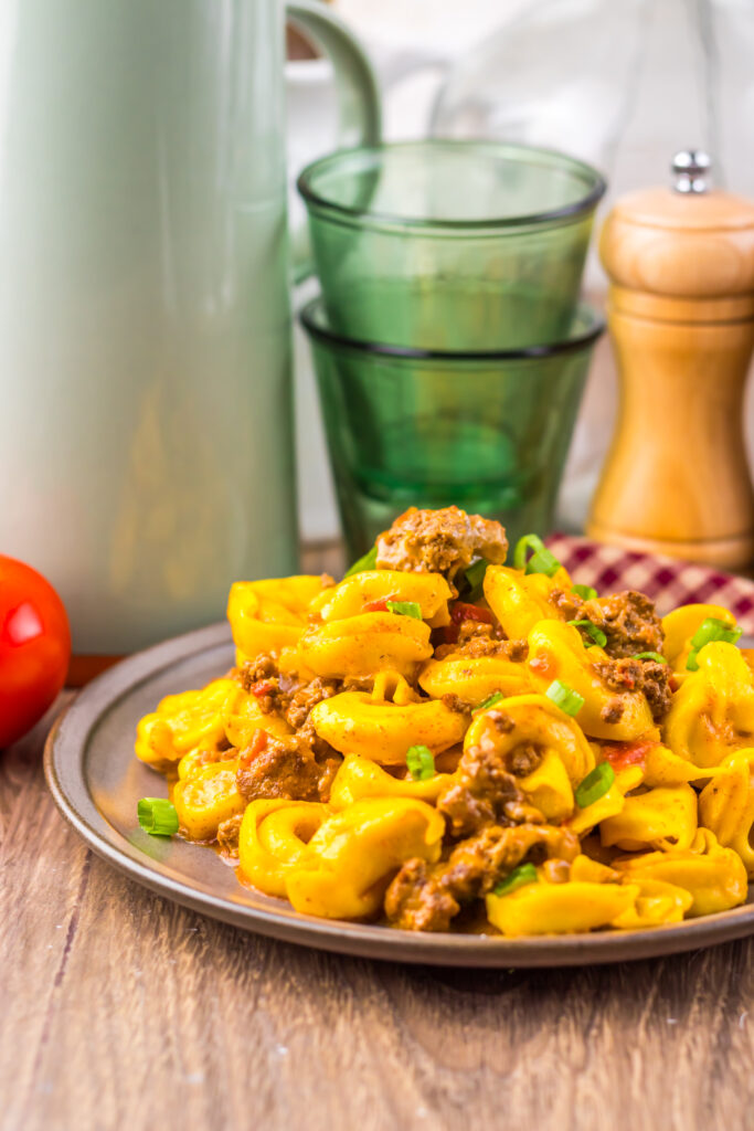Cheesy Slow Cooker Taco Tortellini with ground beef and taco seasoning ready to serve.