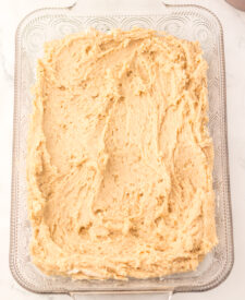 Snickerdoodle Cobbler batter spread evenly in a baking dish before baking.