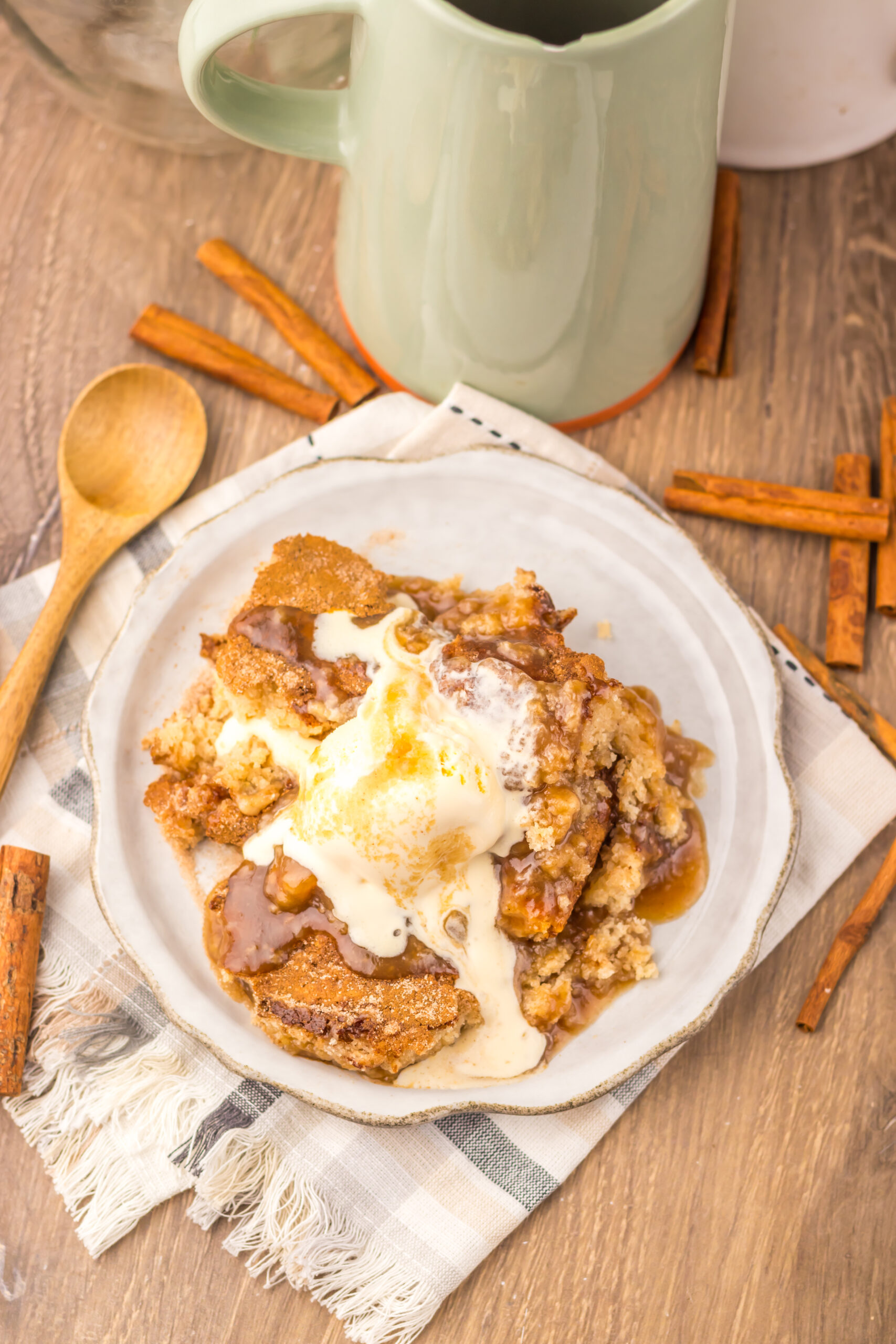 Overhead view of Snickerdoodle Cobbler topped with vanilla ice cream and cinnamon.