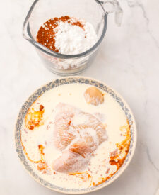 Flour and spicy seasonings prepared for homemade Chick-fil-A Spicy Deluxe Chicken Sandwiches.
