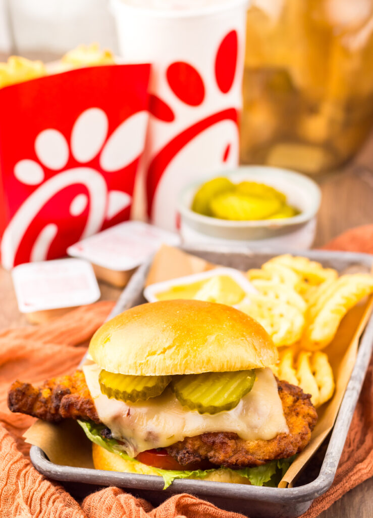 Homemade Chick-fil-A Spicy Deluxe Chicken Sandwich served with waffle fries and dipping sauce.