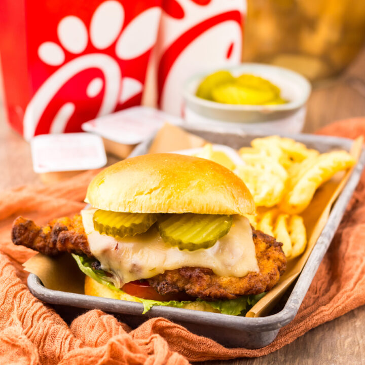 Crispy spicy chicken sandwich with melted cheese and fresh toppings served Chick-fil-A style.