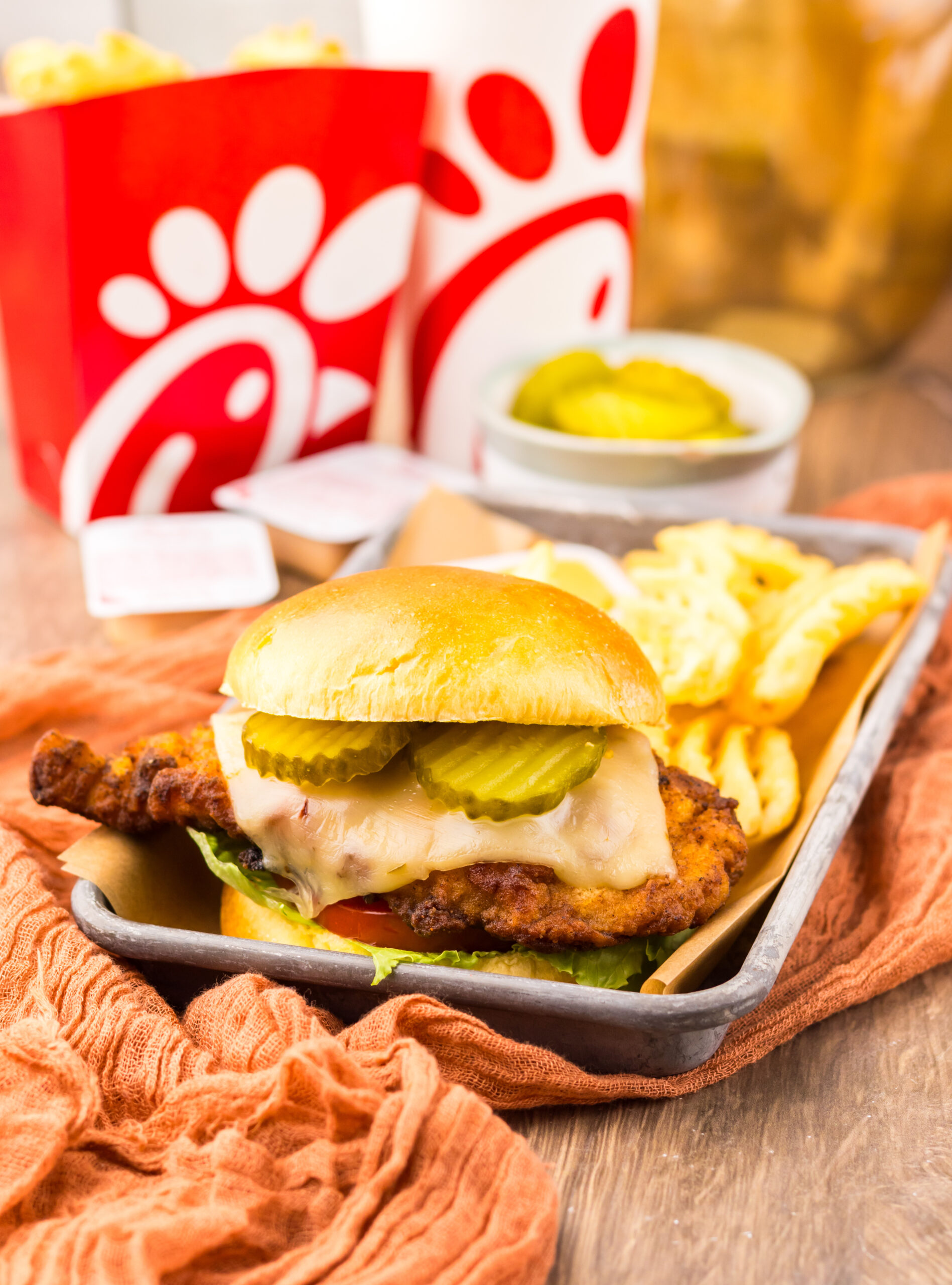 Crispy spicy chicken sandwich with melted cheese and fresh toppings served Chick-fil-A style.