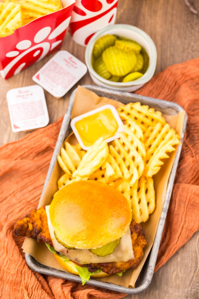 Copycat Chick-fil-A Spicy Deluxe Chicken Sandwich with crispy chicken, cheese, lettuce, and tomato on a toasted bun.