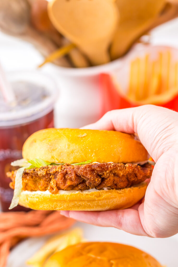 1. Close-up of the crispy spicy chicken patty and toppings on a McDonald’s Hot & Spicy Chicken Sandwich.