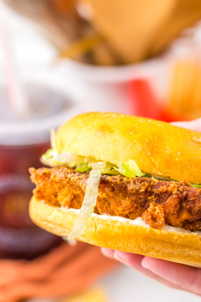 1. Close-up of the crispy spicy chicken patty and toppings on a McDonald’s Hot & Spicy Chicken Sandwich.