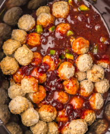 Frozen meatballs with cranberry sauce and sweet chili sauce added to the slow cooker.