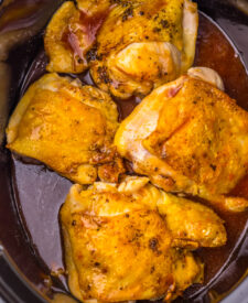 Tender Slow Cooker Honey Bourbon Chicken Thighs coated in a sticky bourbon glaze.