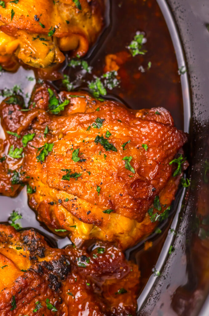 Glazed Honey Bourbon Chicken Thighs topped with fresh herbs.