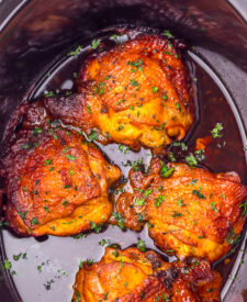 Slow Cooker Honey Bourbon Chicken Thighs cooking in a sweet and savory bourbon sauce.